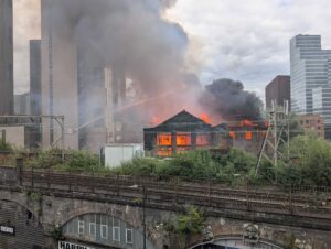 Huge fire breaks out in Manchester with people evacuated and train lines blocked